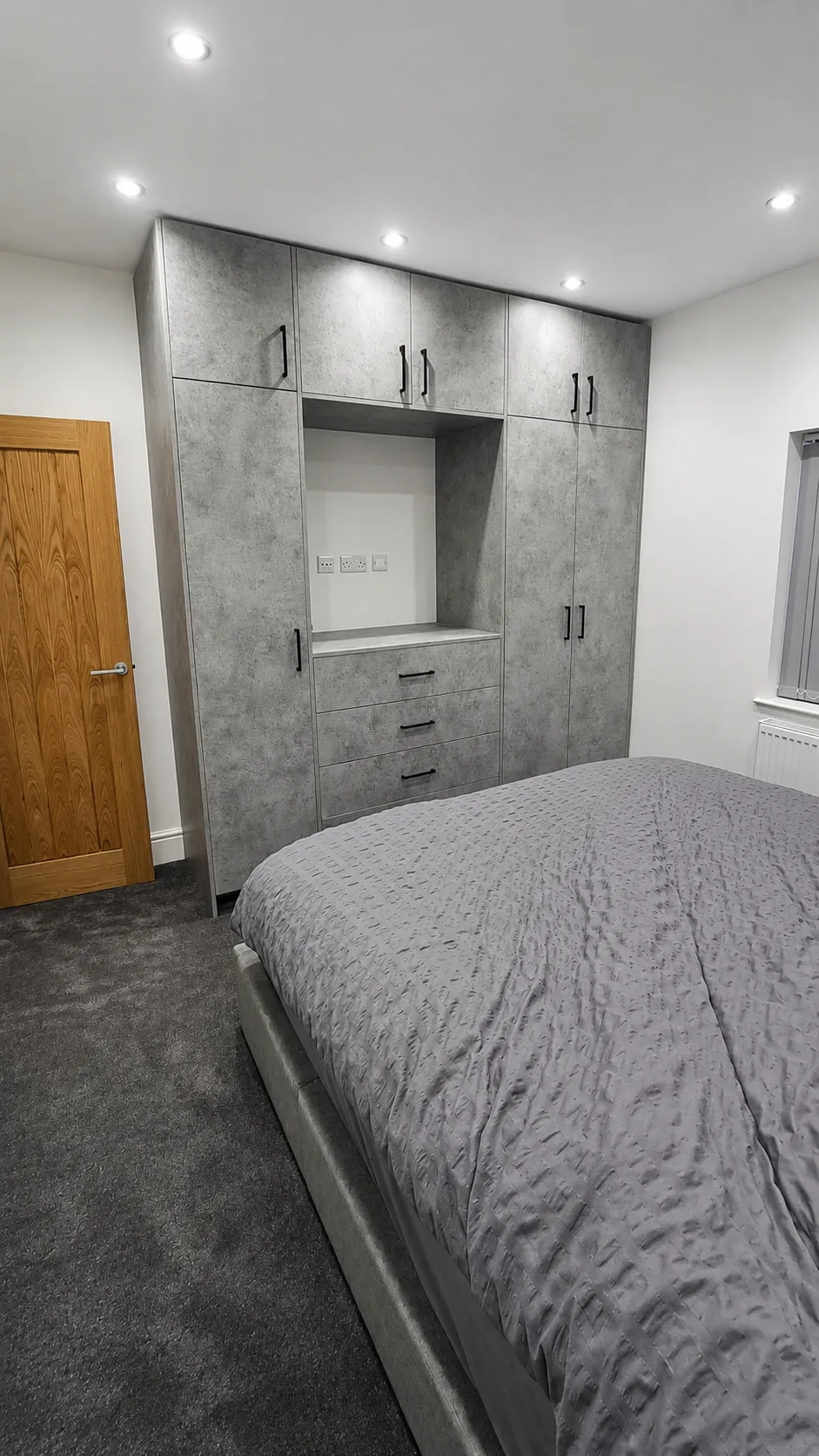 Master bedroom — bespoke floor-to-ceiling fitted wardrobes with integrated dressing area.