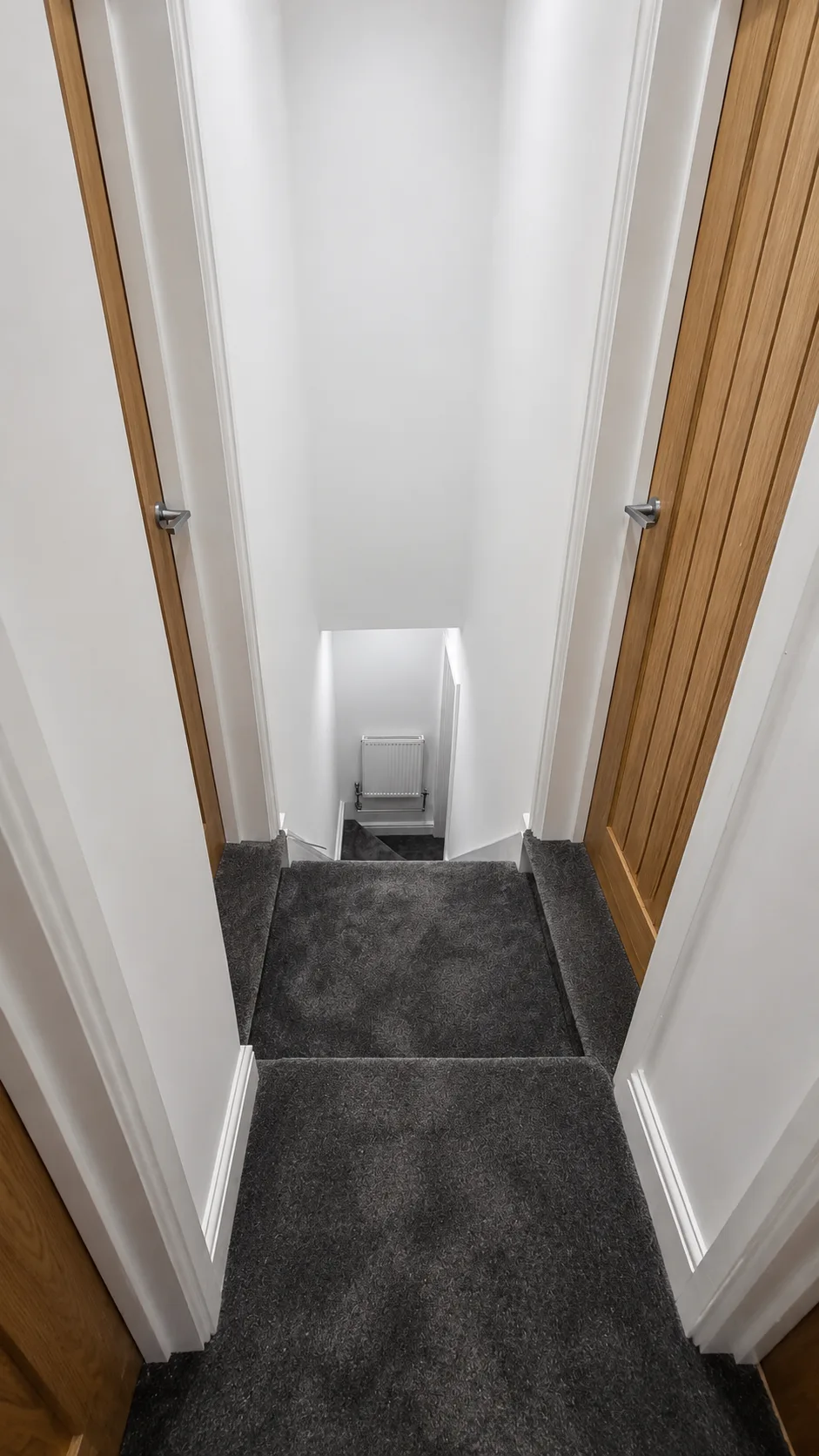 Landing and stairs — new carpet, fresh paint and oak doors throughout.