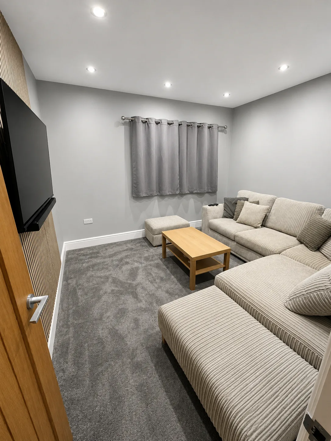 Living room — corner sofa, soft furnishings and full window dressing.
