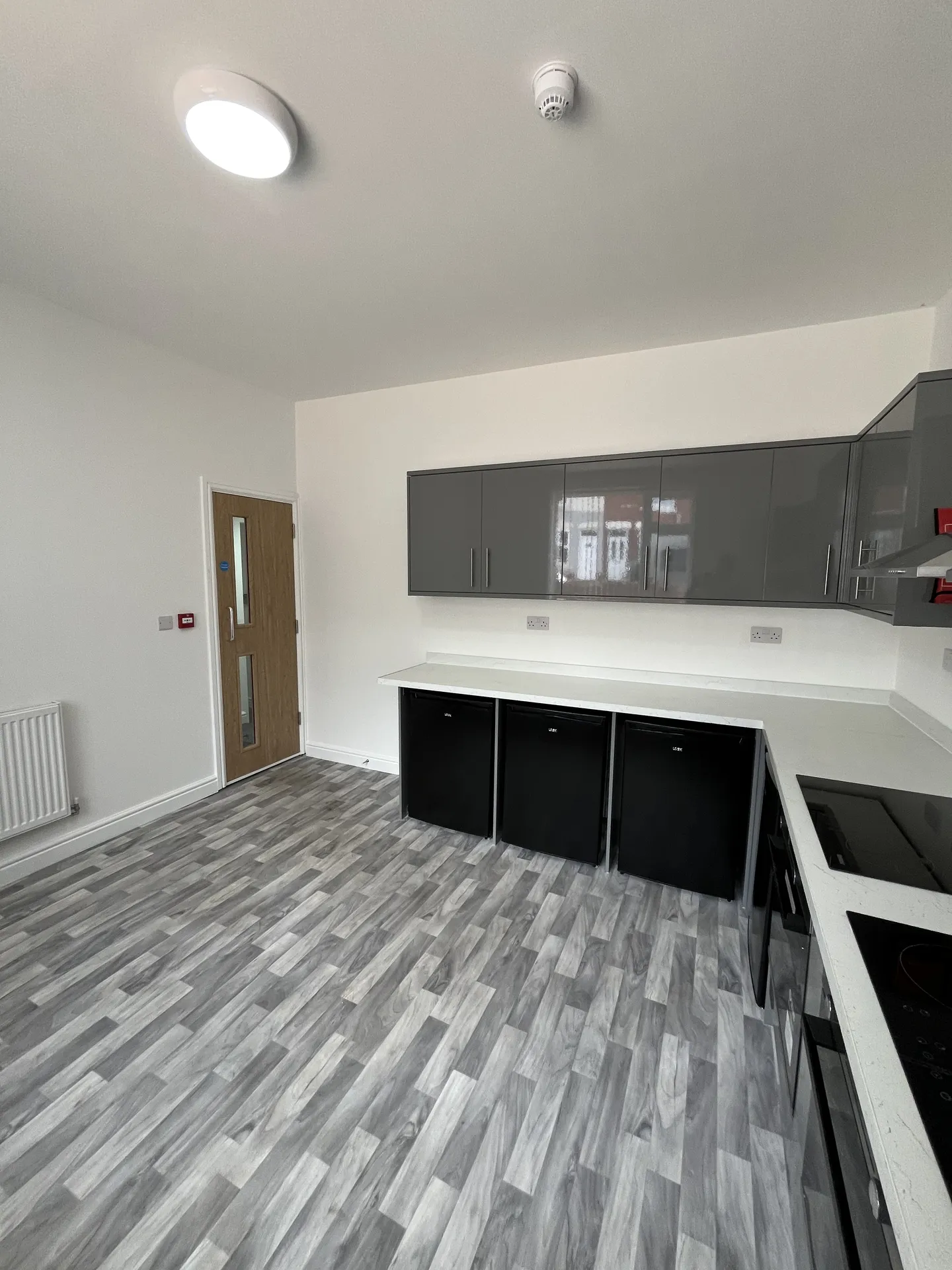 Kitchen storage — multiple fridge units, full prep counter and ample worktop space.