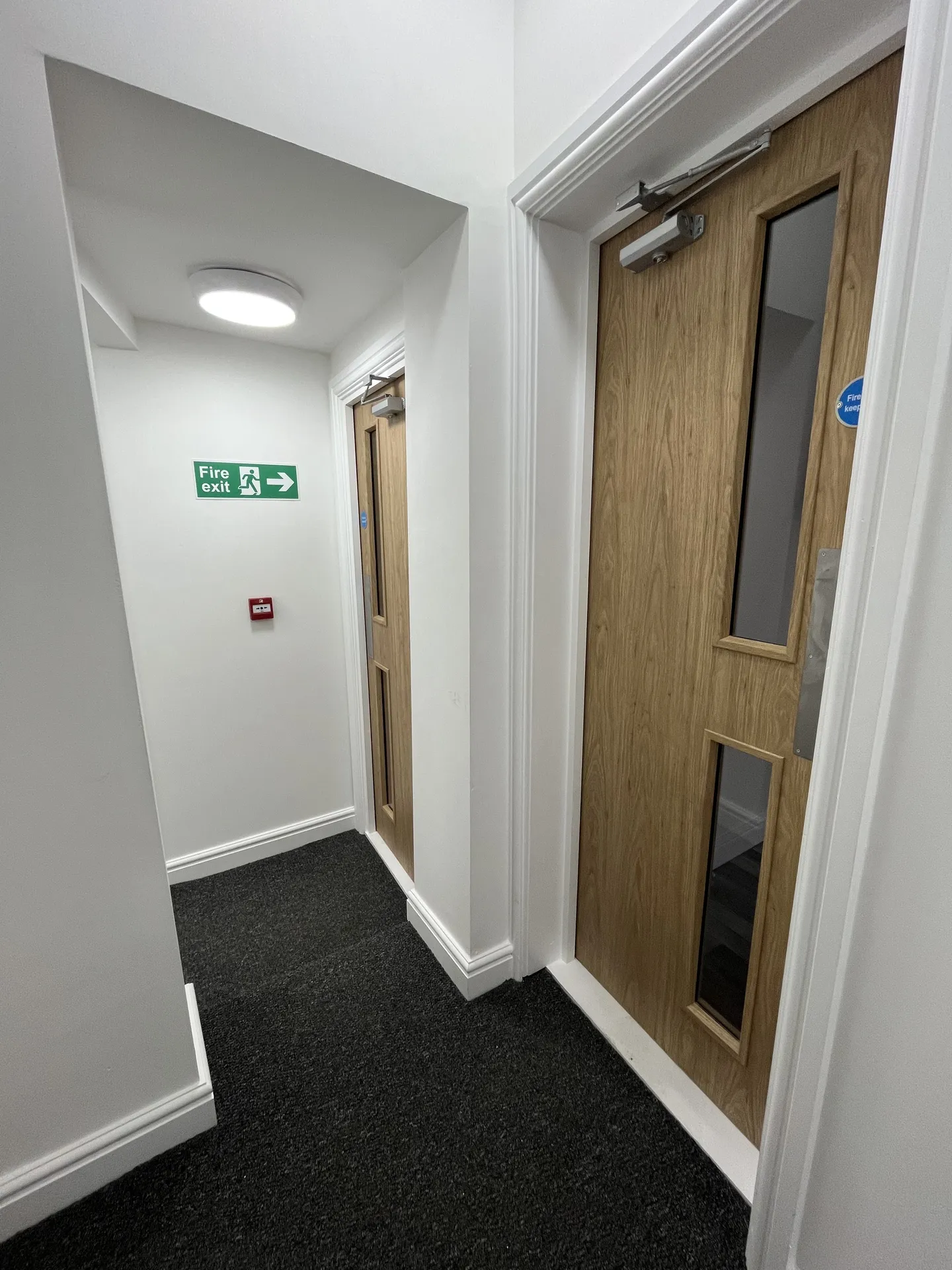 Staircase and landing — fire-rated doors, escape signage and full HMO compliance throughout.
